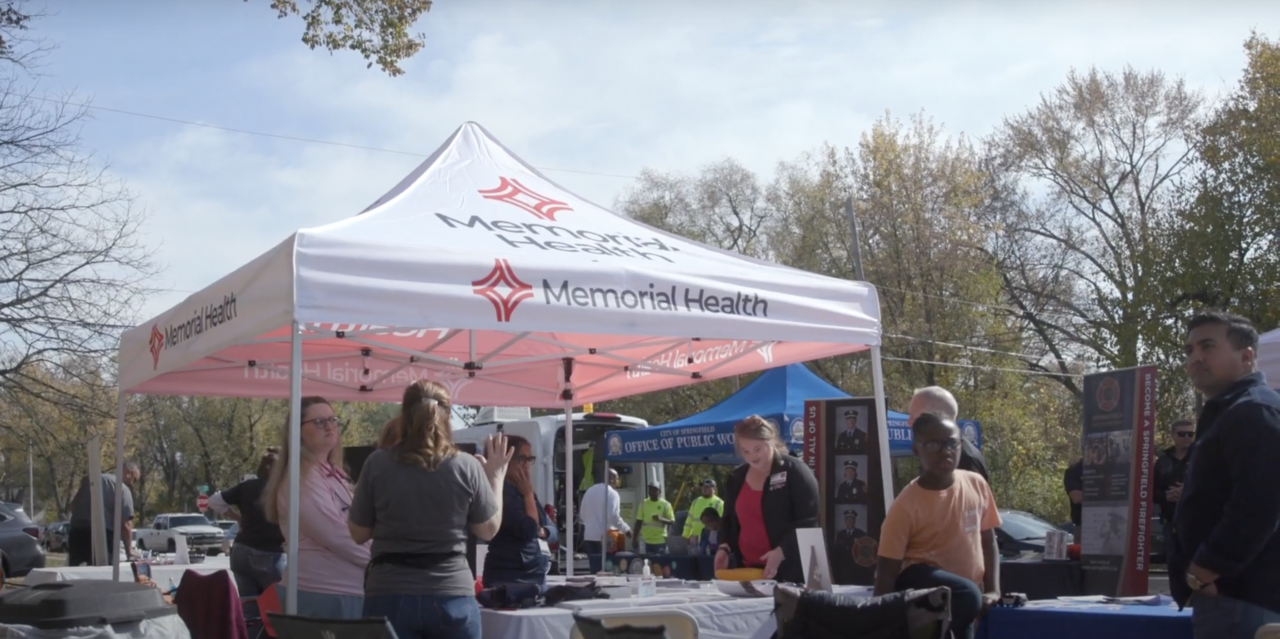 a group of people standing under a tent