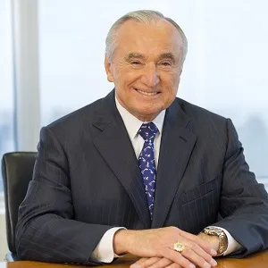 a man in a suit and tie sitting at a desk