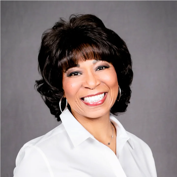 a smiling woman in a white shirt