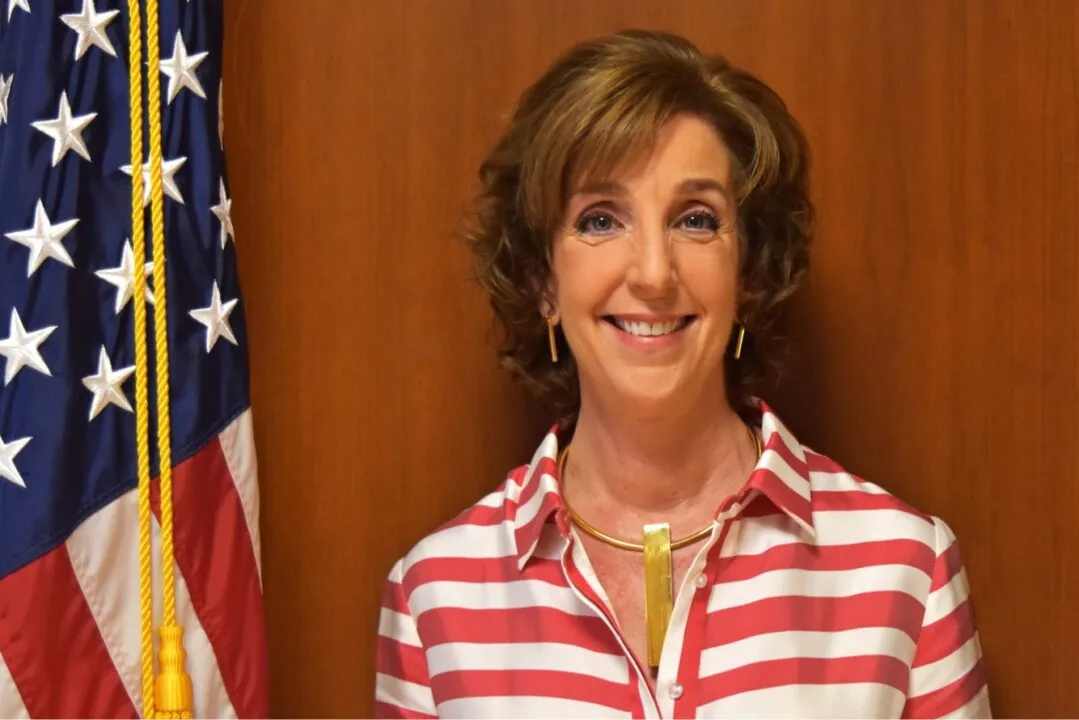 a woman standing in front of an american flag