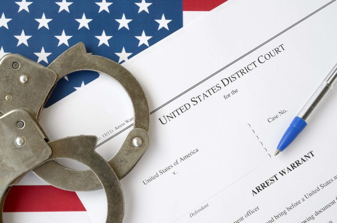 Handcuffs on an arrest warrant