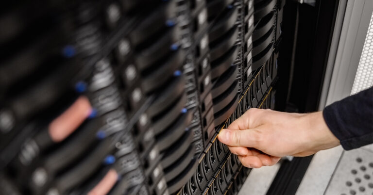 a person is touching a server in a server room