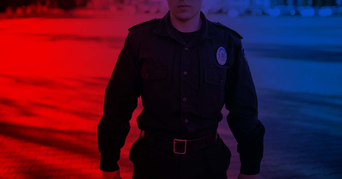 Police officer standing in front of sirens