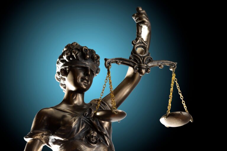 a statue of lady justice holding a balance scale