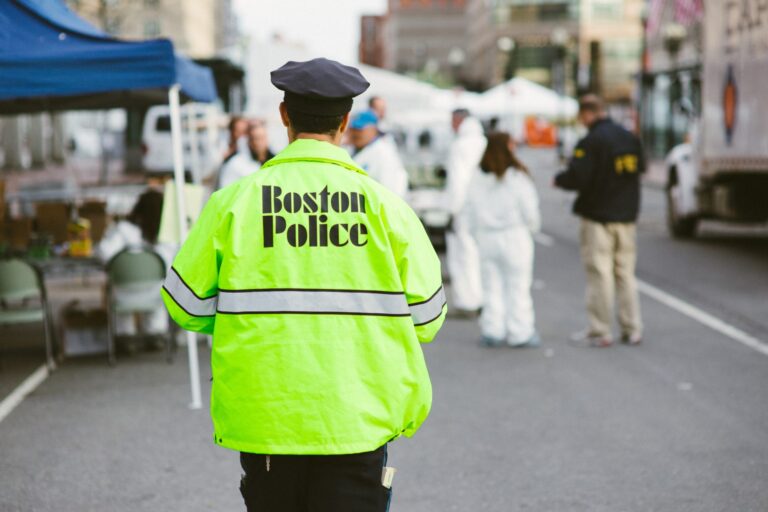 a boston police officer walking down a street