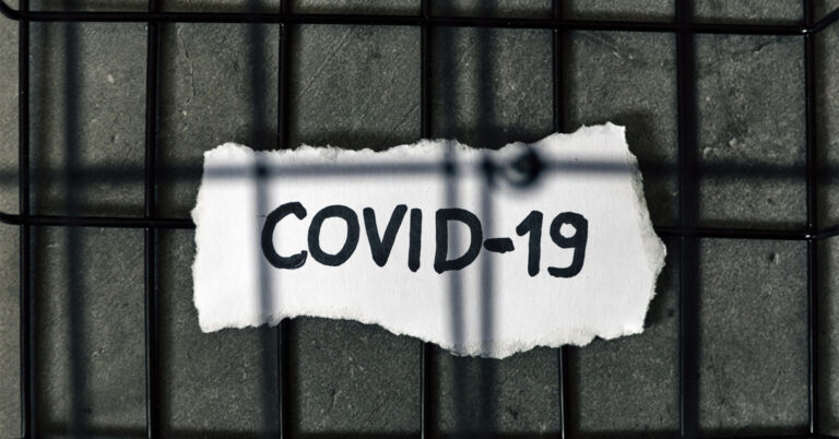 a piece of paper with the word covid - 19 written on it