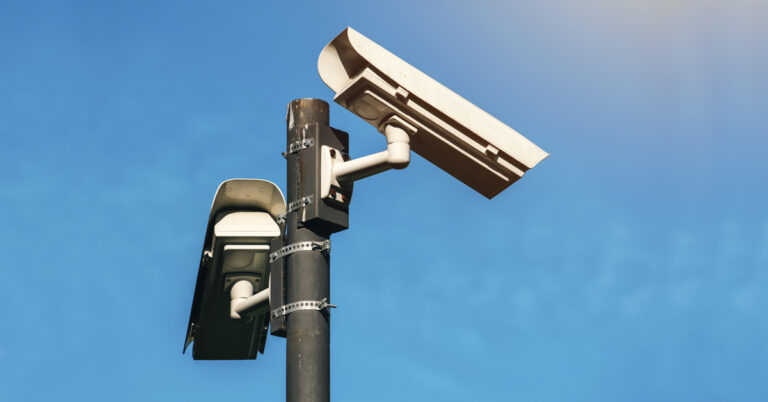 a street light with a camera attached to it