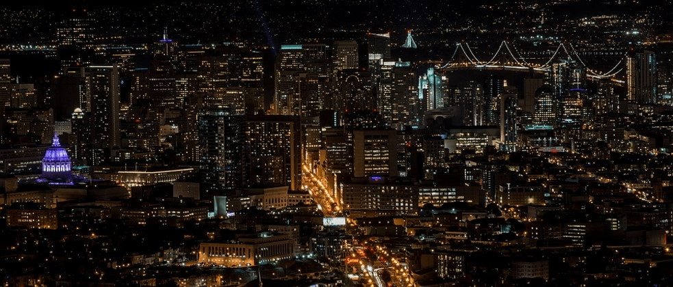 a view of a city at night from the top of a building