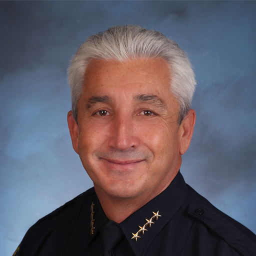 a police officer is smiling for a picture