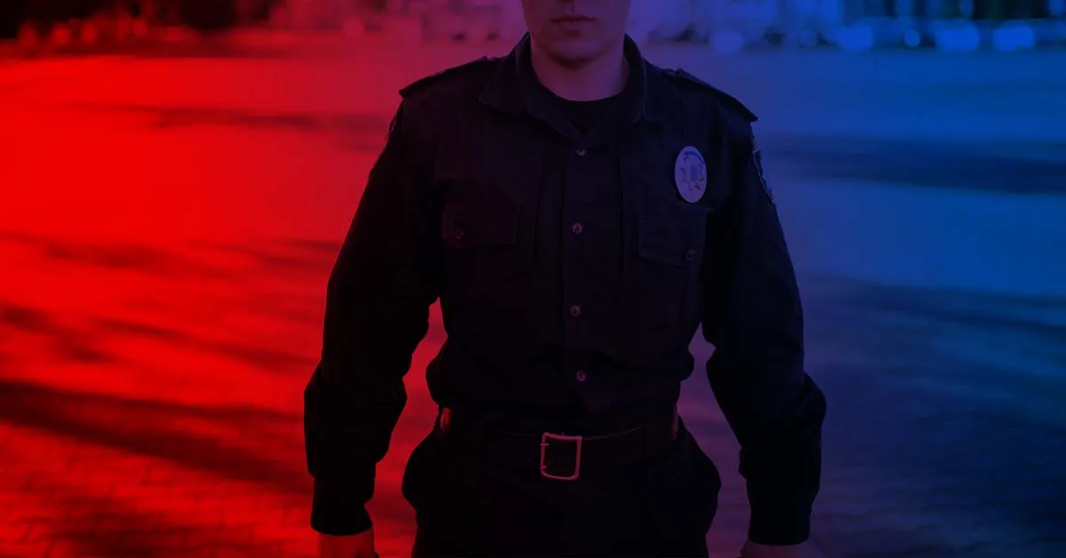 policeman standing against red background