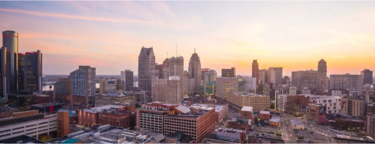 a view of a city at sunset from the top of a building