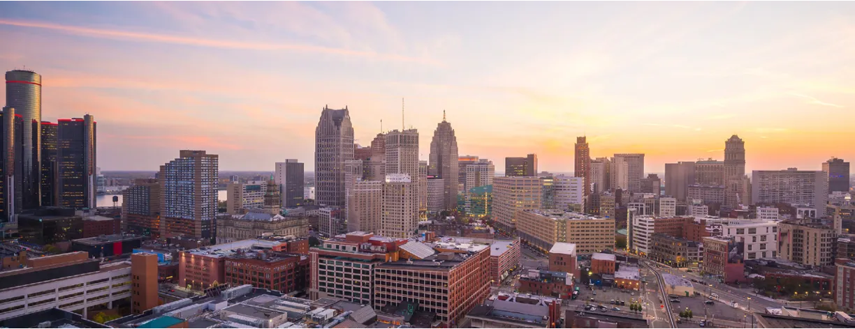 a view of a city at sunset from the top of a building