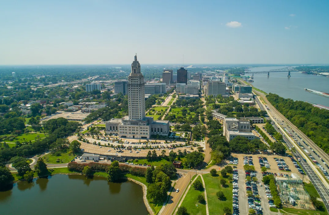 an aerial view of a city with a lake in the foreground