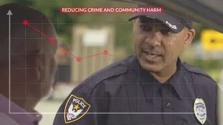 Video: a police officer standing in front of a graph