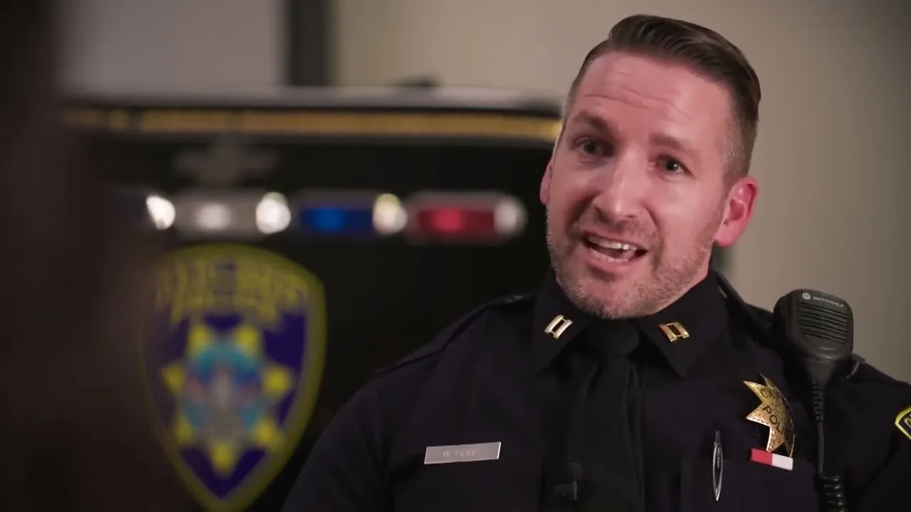 Video: a man in a police uniform talking into a microphone