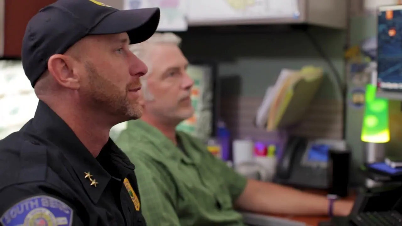 Video: a couple of men sitting at a computer desk