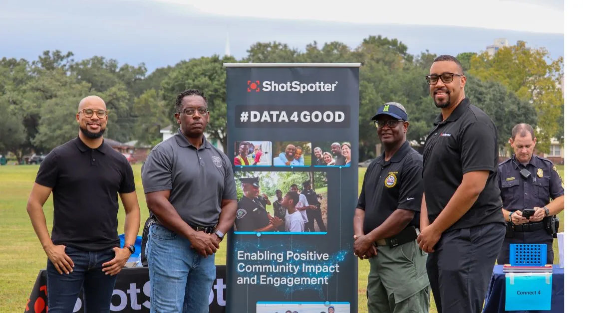 a group of men standing next to a sign