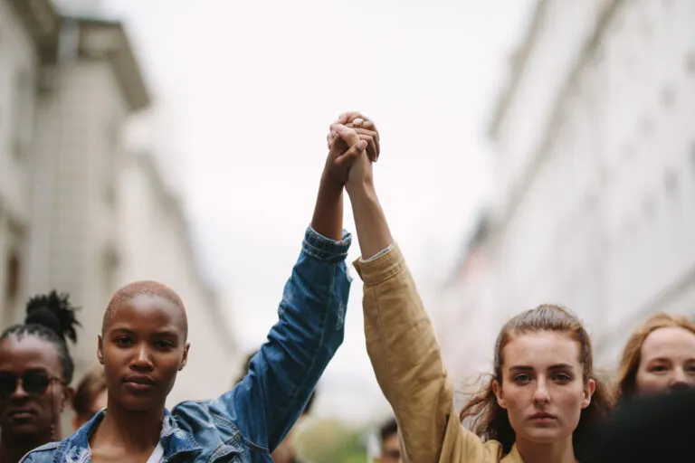 a group of people holding hands in the air