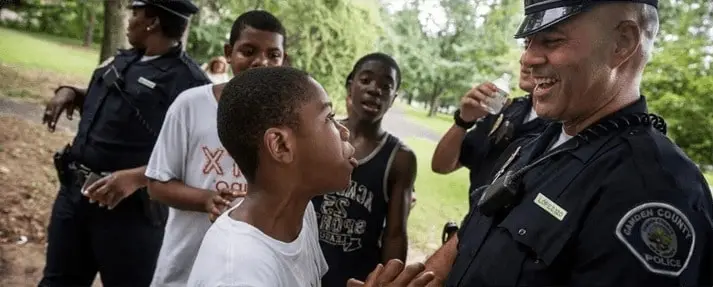 a police officer talking to a young boy