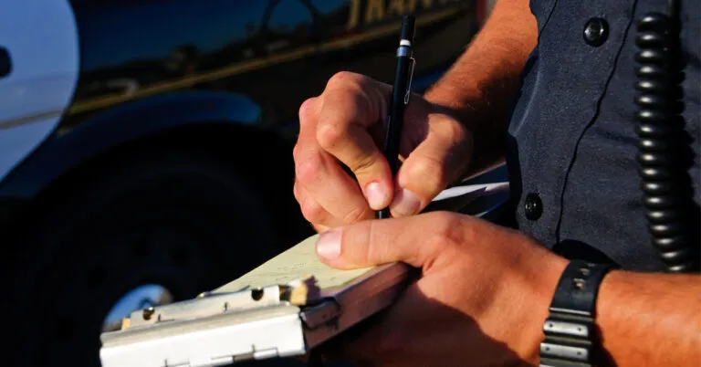 a man is writing on a piece of paper