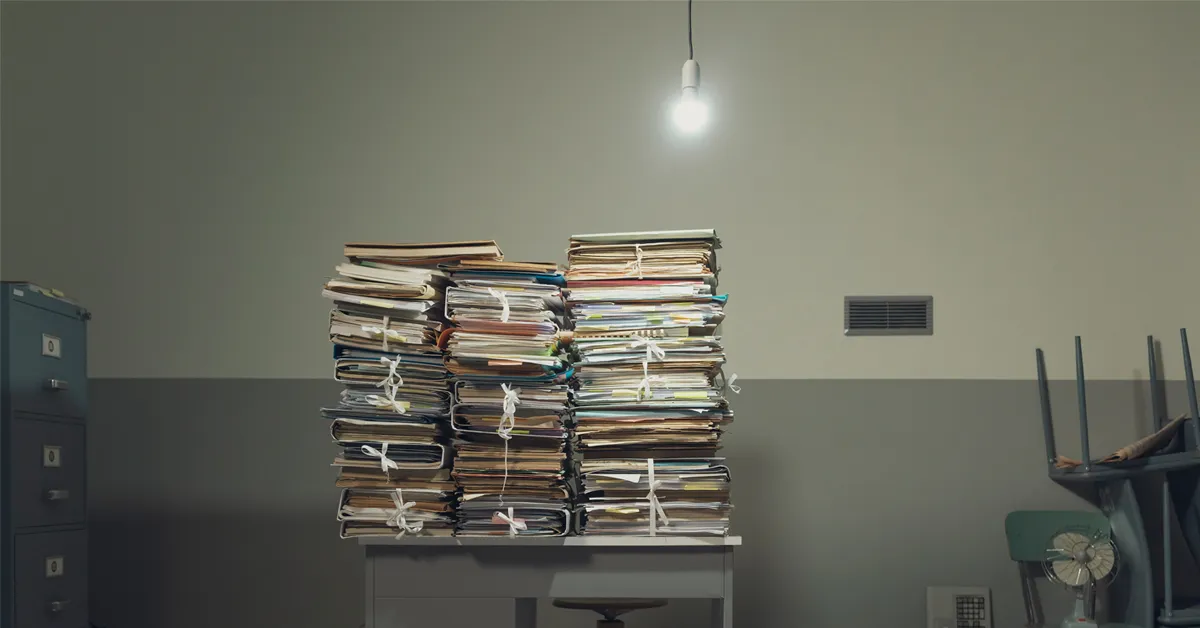 a large stack of papers sitting on top of a table