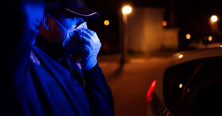 a man in a hat and coat talking on a cell phone