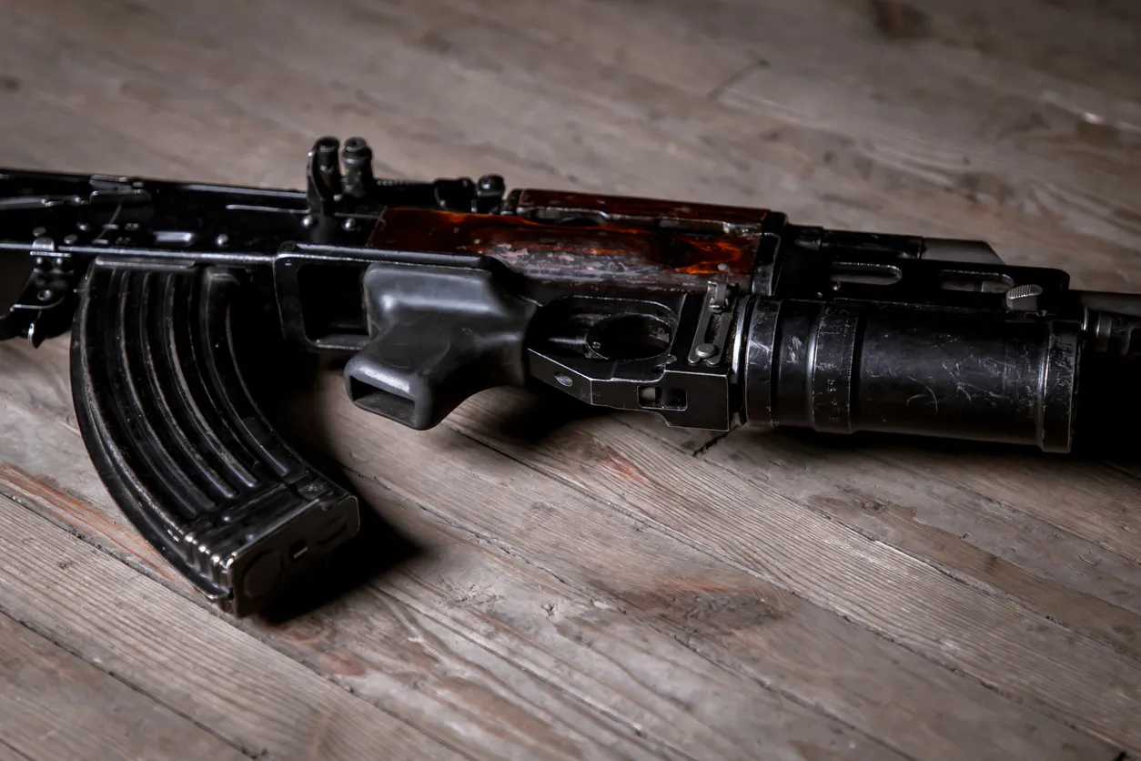 a machine gun laying on top of a wooden floor