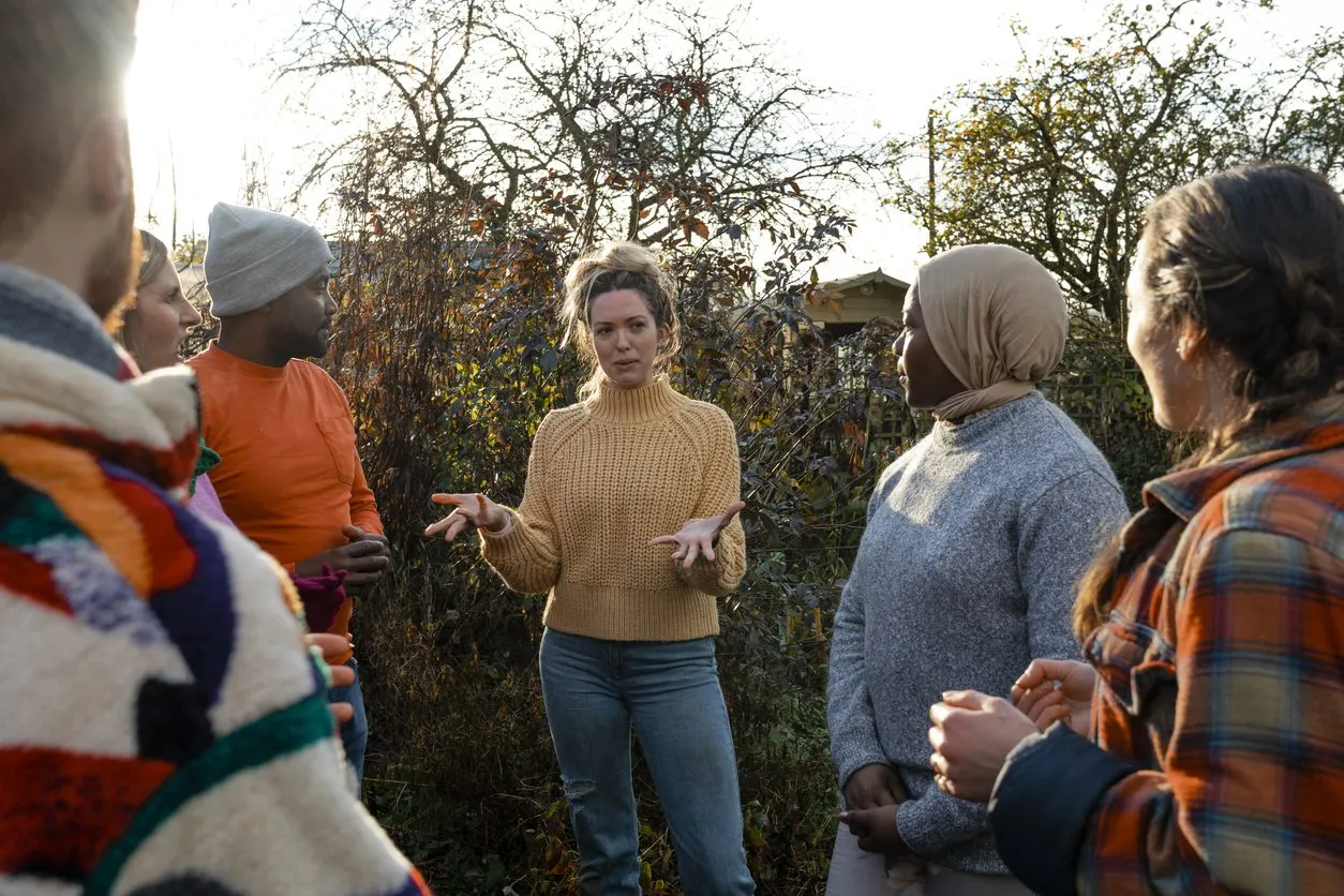 a group of people standing around each other