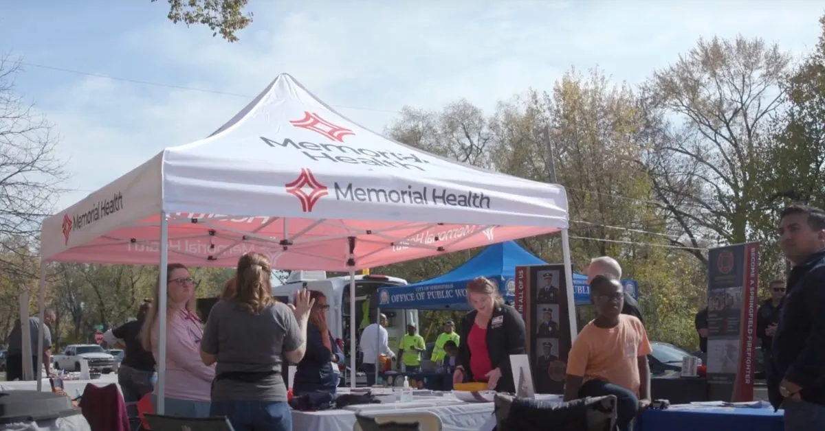 a group of people standing under a tent