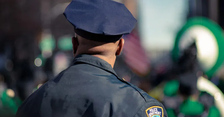 a man in a police uniform standing in the street