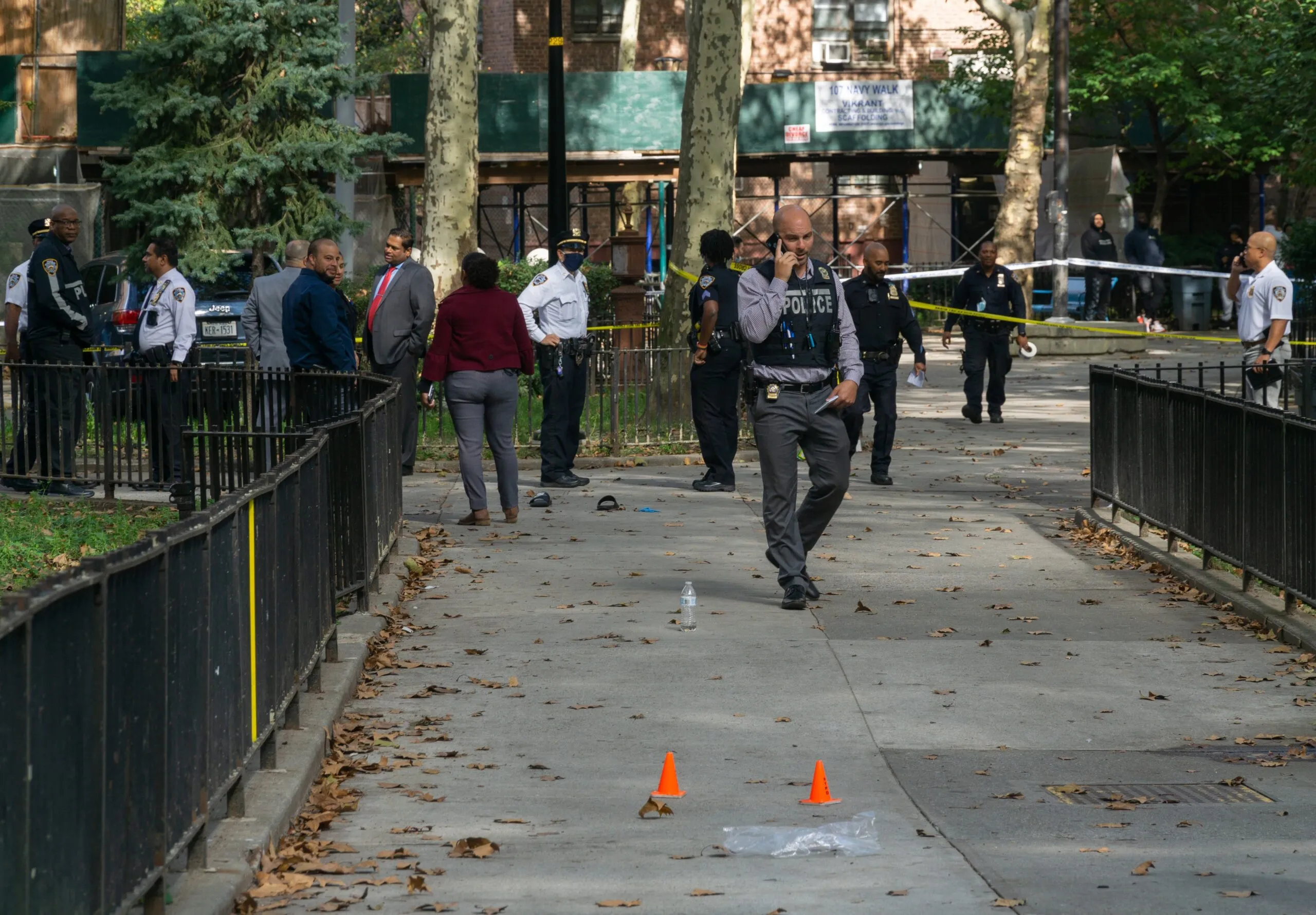 a group of people walking down a sidewalk