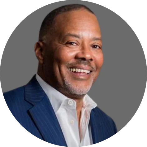 a smiling man in a blue suit and white shirt