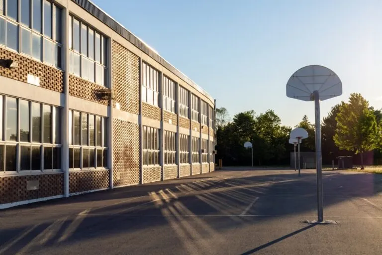 a street with a basketball hoop and a building