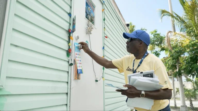 a man in a yellow shirt and a blue hat