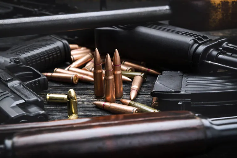 a close up of a bunch of guns on a table