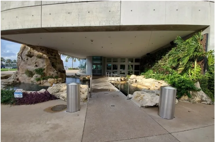 a concrete building with a walkway leading to it