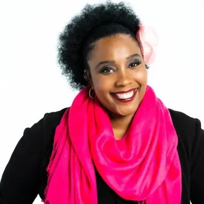 a woman wearing a pink scarf and smiling